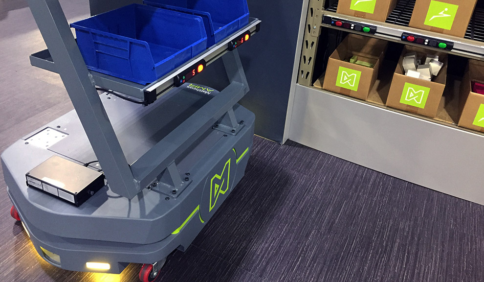 Matthews autonomous robot with picking attachment stopping at pick-to-light shelves