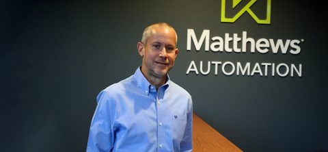 Peter Gerbitz, Lightning Pick Systems Sales Manager at Matthews Automation, standing in the lobby of Matthews' Waukesha WI office.