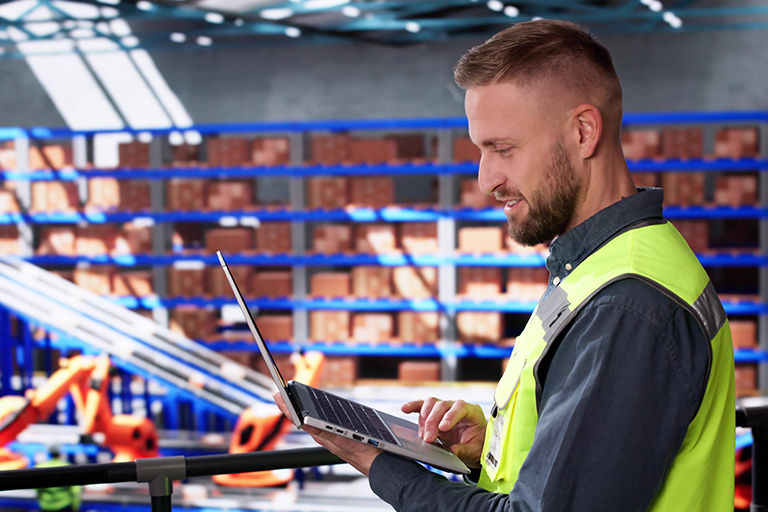 Distribution center employee securely logging into a warehouse execution system software to manage warehouse automation.