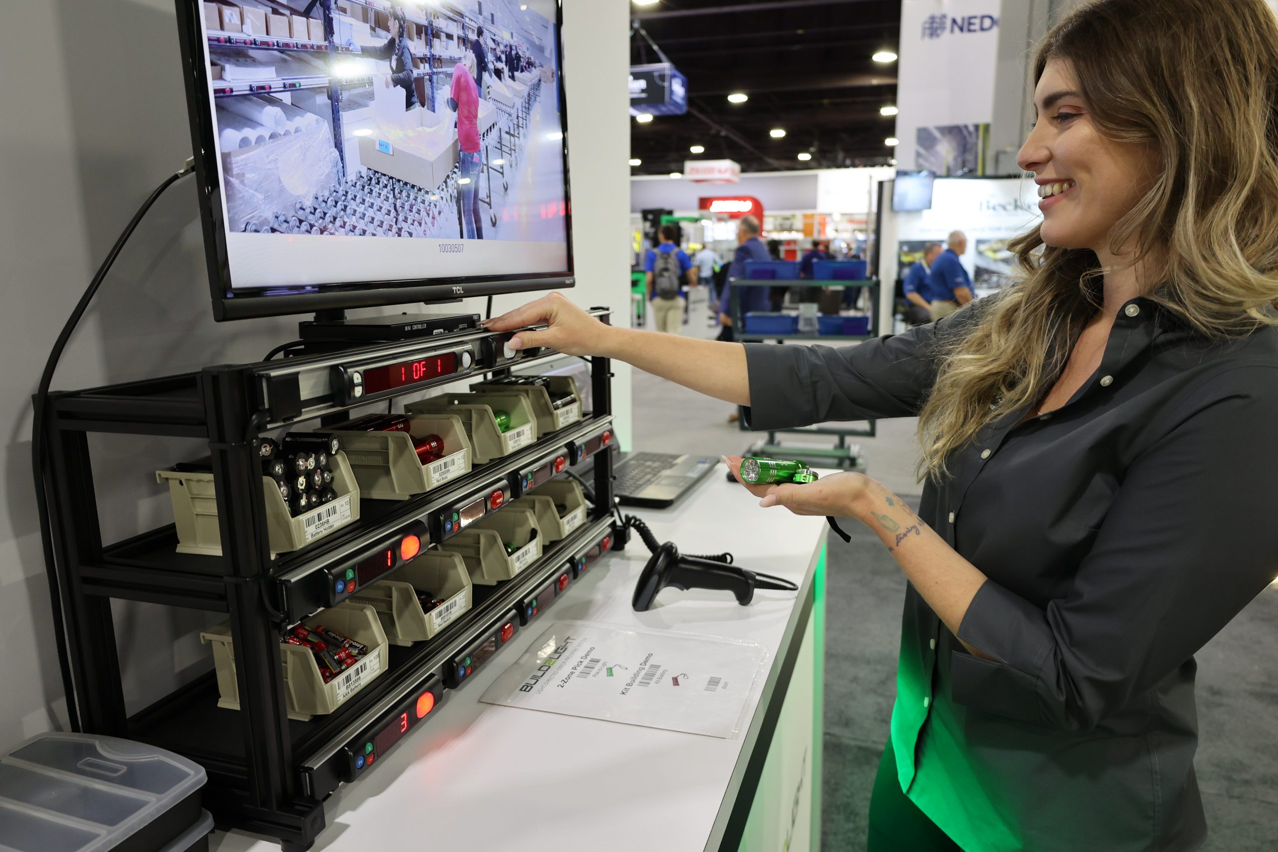 Operator performing pick-to-light demo in a trade show booth