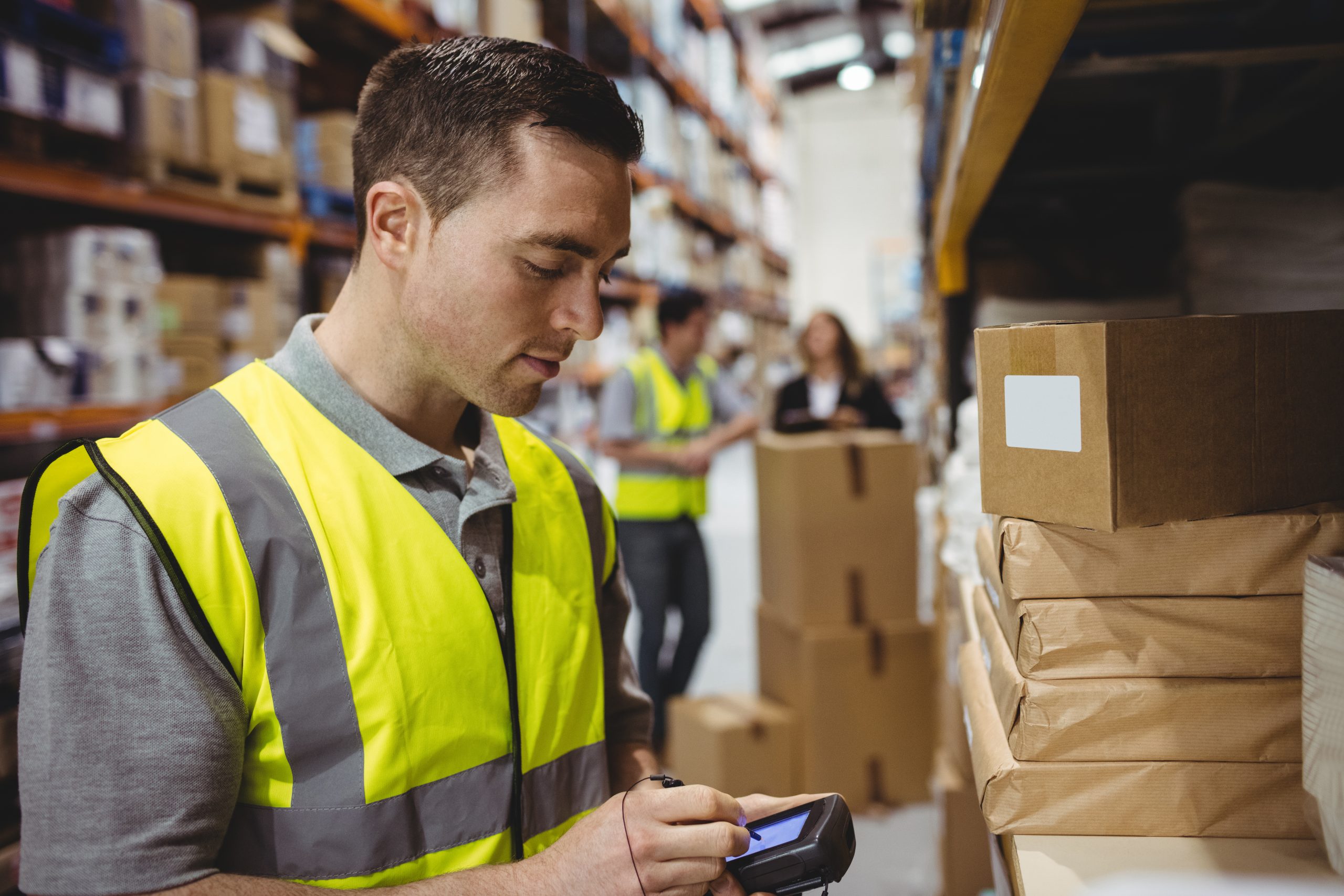 Warehouse worker uses RF terinal to pick orders