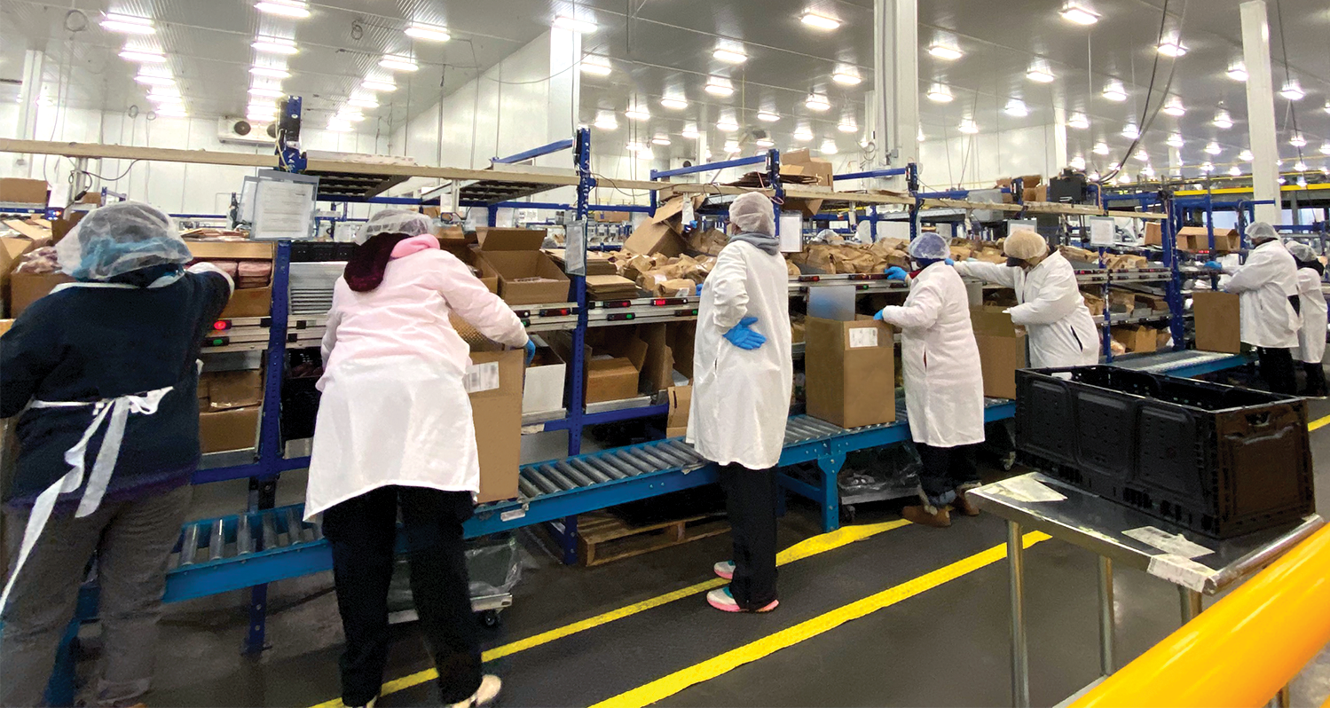 workers packing orders in an e-grocery facility
